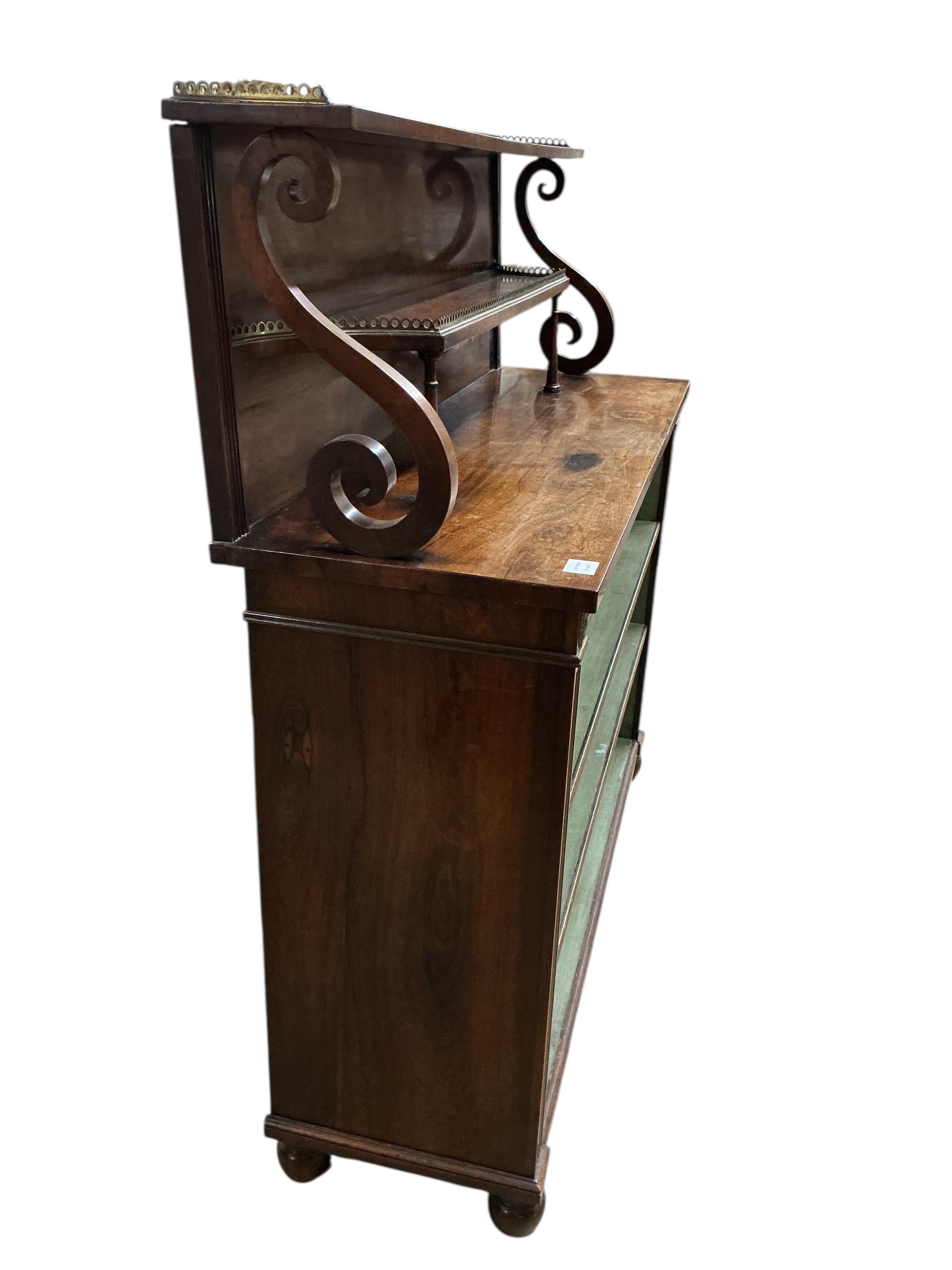 A Regency rosewood and brass mounted side cabinet, width 124cm, depth 41cm, height 132cm